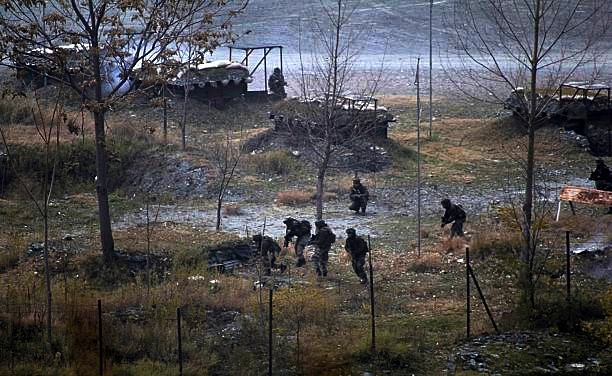 Smoke rises from a bunker as Indian Army soldiers search for suspected terrorists. (Ahmer Khan/Anadolu Agency/Getty Images)