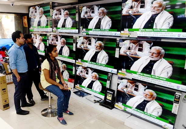 People watch Prime Minister Narendra Modi on Television. (Saikat Paul/Pacific Press/LightRocket via Getty Images)