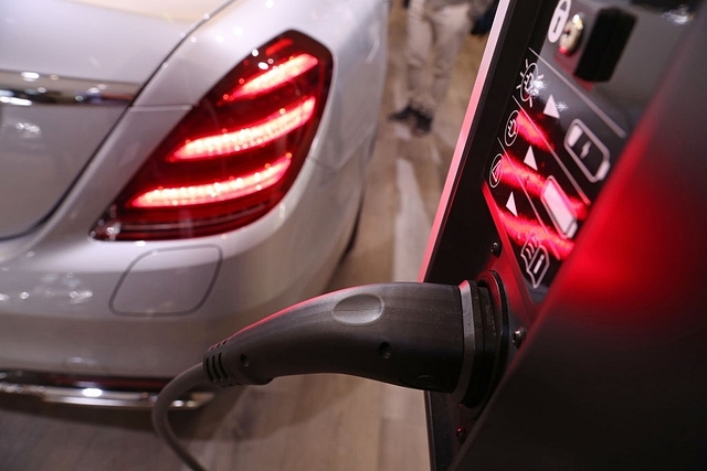 An electric car next to a charging station. (Sean Gallup/GettyImages)