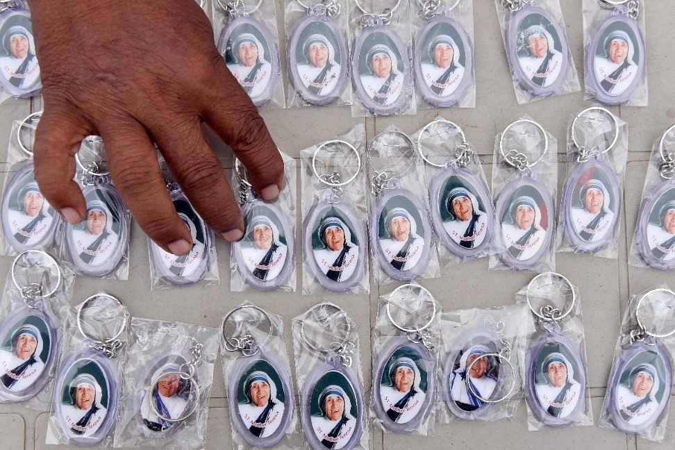 A man sorts key chains of Mother Teresa at Blessed Mother Teresa Church in Virar near Mumbai. (Pratham Gokhale/Hindustan Times via GettyImages)&nbsp;