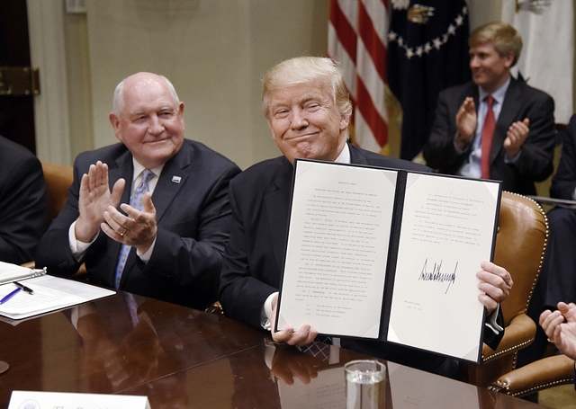 US President Donald Trump with  Agriculture Secretary Sonny Perdue. (Olivier Douliery-Pool/Getty Images)