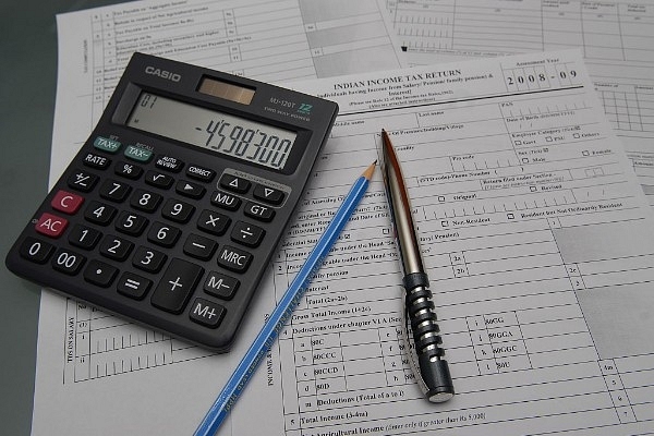 A representative image of Indian income tax return form with calculator and a pen. (Rajkumar/Mint via Getty Images)