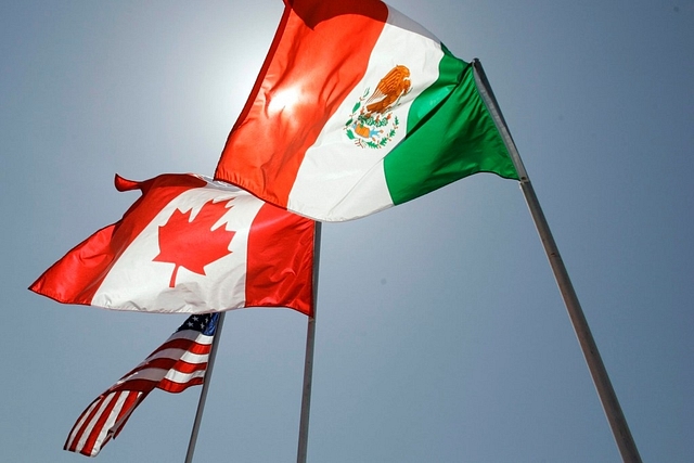 National flags representing the United States, Canada, and Mexico fly in the breeze in New Orleans.