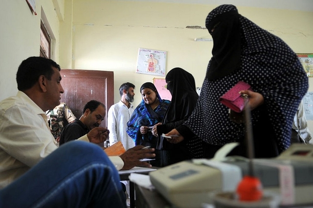 Muslim women voters undergo verification inside a polling station at Gujjar Nagar in Jammu on 8 October  2018 (Photo by Nitin Kanotra/Hindustan Times via Getty Images)