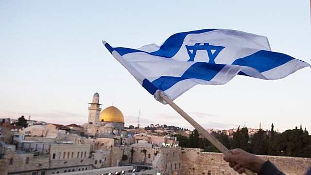 Israelis wave their national flags during a march next to the Western Wall as a part of observing the Jerusalem Day (Lior Mizrahi/Getty Images)