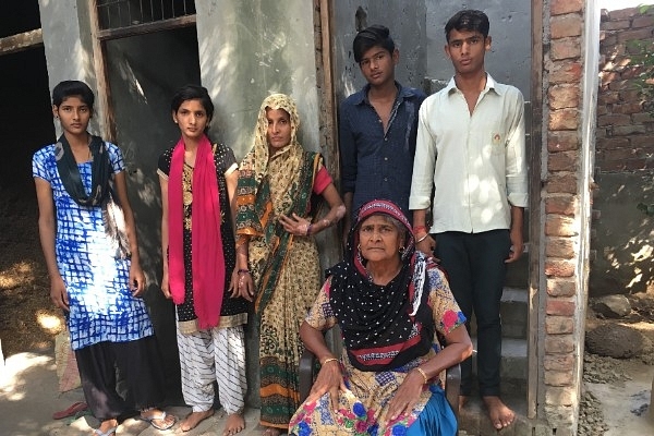 Lajjawati (sitting) with Balhara’s wife (in sari) and four children at their house in Palwal on October 17