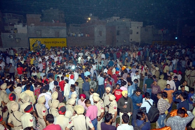  Police and locals gathered around dead bodies on October 19, 2018 in Amritsar. Several people were killed after a train ran into crowds at Joda Phatak crossing. (Photo by Sameer Sehgal/Hindustan Times via Getty Images)