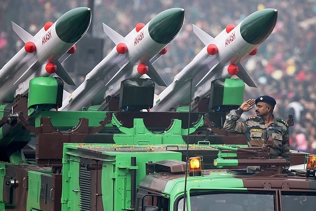 An Indian soldier salutes as he rides an Akash weapon system of air defence during India’s Republic Day parade in New Delhi (ROBERTO SCHMIDT/AFP/Getty Images)