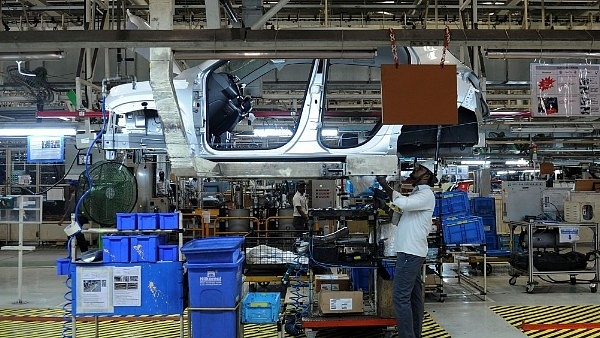 Indian workers labour on assembly lines of components for Datsun Go and Renault Kwid vehicles (ARUN SANKAR/AFP/Getty Images)