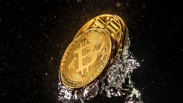 A visual representation of the digital currency Bitcoin sinks into water. (Dan Kitwood/Getty Images)