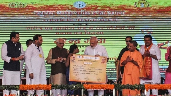  Prime Minister Narendra Modi gives a certificate of Prime Minister’s Housing Scheme during a public meeting, on September 23, 2017 in Varanasi. (Rajesh Kumar/Hindustan Times via Getty Images)