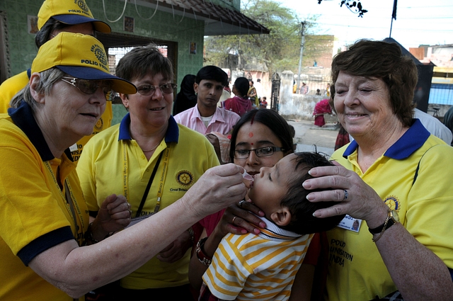  Foreign national administering Polio vaccine to a child at Sehraul village. (Parveen Kumar/ Hindustan Times via Getty Images)