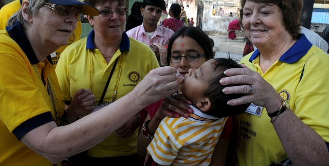  Foreign national administering Polio vaccine to a child at Sehraul village. (Parveen Kumar/ Hindustan Times via Getty Images)