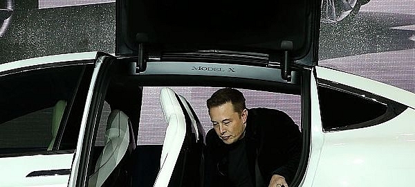 Tesla CEO Elon Musk steps out of the new Tesla Model X at an event (Justin Sullivan/Getty Images)