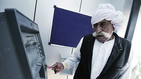 A villager uses an ATM machine to withdraw cash. (Priyanka Parashar/Mint via GettyImages) &nbsp;