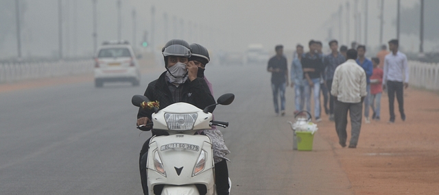 Delhi residents make their way through heavy smog. (Photo by K Asif/India Today Group/Getty Images)