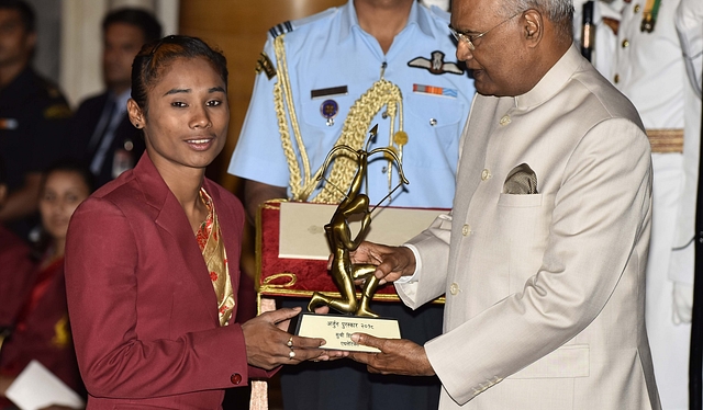 Athletics Hima Das receives Arjuna Award 2018 for her achievements in Athletics from President Ramnath Kovind during the National Sports and Adventure Award 2018 function, at Rashtrapati Bhawan. (Vipin Kumar/Hindustan Times via Getty Images)