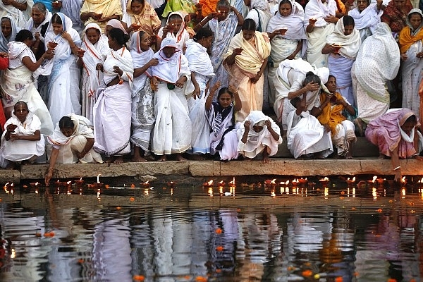 Widows of Vrindavan lighting earthen lamps at the banks of Yamuna River as they begin their three-day Diwali celebrations  in Vrindavan, India. (Ajay Aggarwal/Hindustan Times via Getty Images)