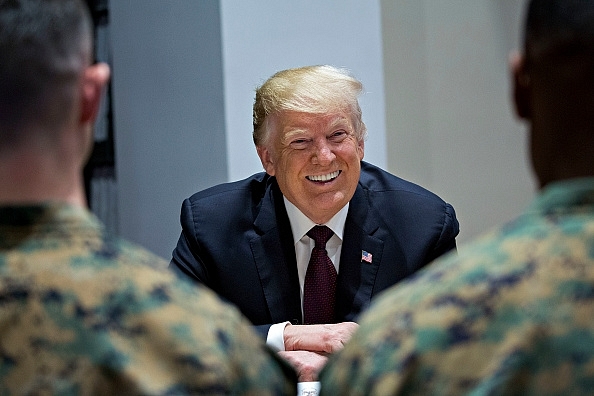 US President Trump smiles in a meeting with US marines in Washington, D.C. (Photo by Andrew Harrer-Pool/ Getty Images)