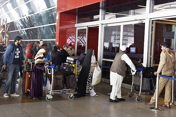 Passengers waiting to enter Delhi Airport (Sushil Kumar/Hindustan Times via Getty Images)