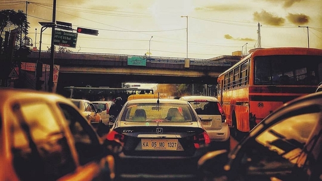 A passenger enjoying sunset after getting stuck at silkboard junction (Supratim Bhattacharya/ image via Facebook)&nbsp;