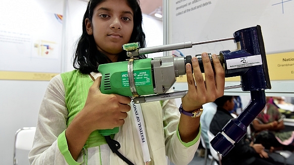 A student showcases a modified drill for collecting dust at the Festival of Innovation and Entrepreneurship in New Delhi. (Mohd Zakir/Hindustan Times via Getty Images)&nbsp;