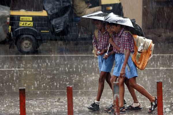 School children on their way back home on a rainy afternoon. (Manoj Patil/Hindustan Times via Getty Images)