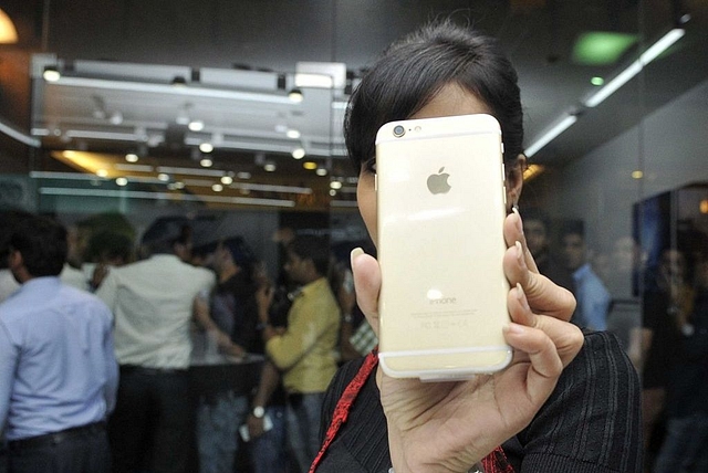 A girl poses with an iPhone in India. (Sunil Ghosh /Hindustan Times via Getty Images)