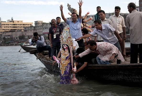 Hindu devotees in Bangladesh immerse a clay idol in the Buriganga River on the last day of Durga Puja in Dhaka. (Photo by Getty Images/Getty Images)&nbsp;