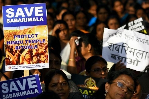 Ayyappa Dharma Samrakshana Samithi members hold placards during a protest against the SC verdict on entry of women into Sabarimala Temple, at Parliament Street, in New Delhi. (Photo by Amal KS/Hindustan Times via Getty Images)&nbsp;