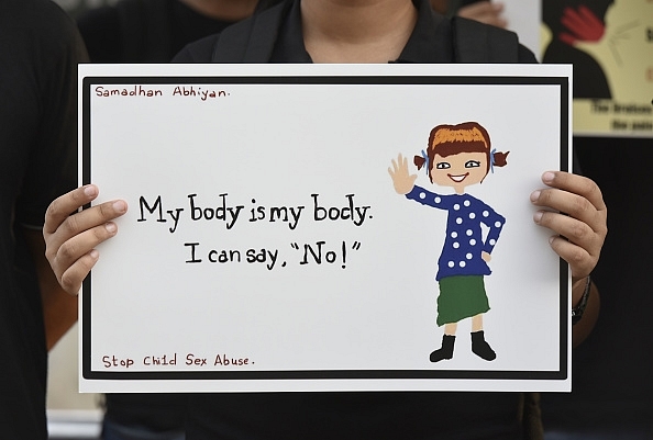 A student’s drawing during the Child Sexual Abuse Awareness Walk in New Delhi. (Photo by Vipin Kumar/Hindustan Times via Getty Images)