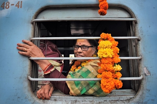 An old woman travelling in train. (Burhaan Kinu/Hindustan Times via Getty Images)
