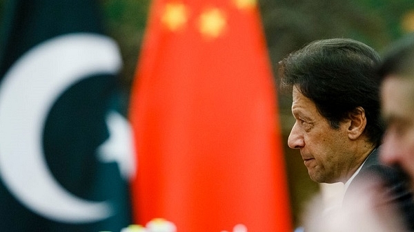 Pak PM, Imran Khan with a Chinese flag in the backdrop (Thomas Peter-Pool/Getty Images)