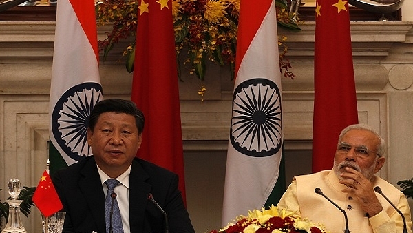 Prime Minister Narendra Modi and Chinese President Xi Jinping (L) (Arvind Yadav/Hindustan Times via Getty Images)