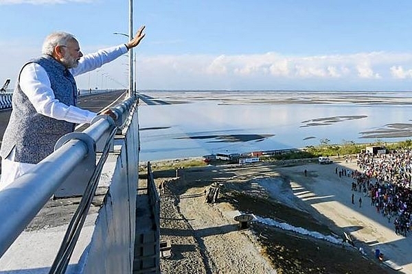 Prime Minister Narendra Modi waves at people after inaugurating the Bogibeel Bridge on Brahmaputra river. (india.com)