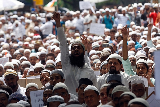 Rohingya Muslim refugees along with Indian supporters hold placards against human rights violations in Myanmar during a protest in New Delhi. (Qamar Sibtain/India Today Group/Getty Images)&nbsp;