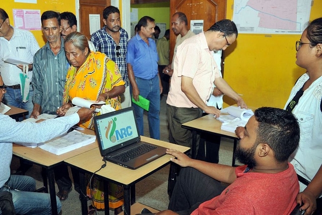 People check their name on the final draft list of Assam’s NRC list at NRC Seva Kendra at Hatigaon in Guwahati. (Rajib Jyoti Sarma/Hindustan Times via GettyImages)