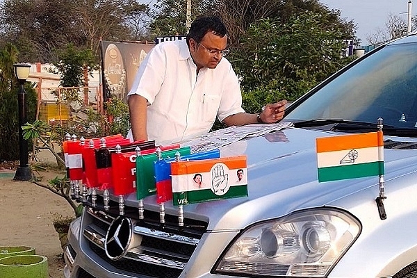 Karti Chidambaram reading a newspaper on his Mercedes (@KartiPC/Twitter)