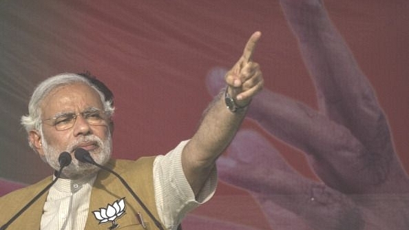 Prime Minister Narendra Modi gestures while speaking to the crowd at a rally in Sidhuali, near Lucknow, India. (Kevin Frayer/Getty Images)