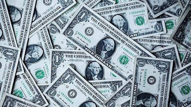 US Dollar bills. (Unsplash/Sharon McCutcheon)