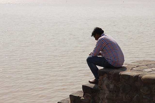 A disheartened youth on the shore of Sukhna Lake, Chandigarh, Punjab (Image by <a href="https://pixabay.com/users/Jeevan-604776/?utm_source=link-attribution&amp;utm_medium=referral&amp;utm_campaign=image&amp;utm_content=724005">Jeevan Singla</a> from <a href="https://pixabay.com/?utm_source=link-attribution&amp;utm_medium=referral&amp;utm_campaign=image&amp;utm_content=724005">Pixabay</a>)