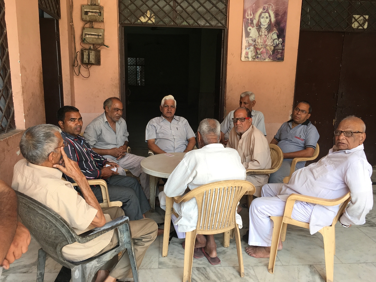 A group of men playing cards in Tyagi dharamshala on Wednesday