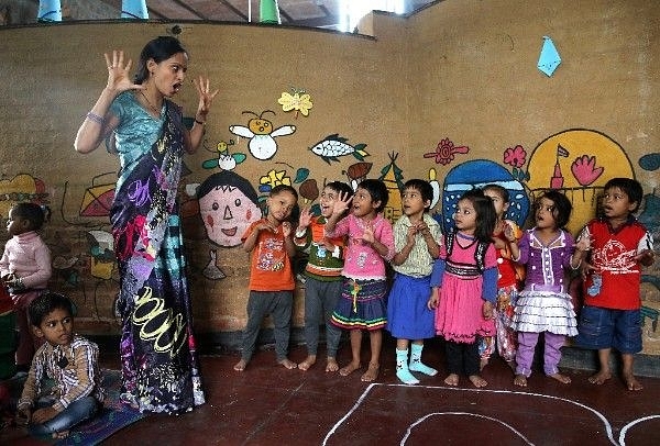 Draft NEP lays stress on early childhood learning. A teacher leads a lesson at Katha Community School in Govindpuri slum district of Delhi. (Chris Jackson/Getty Images)