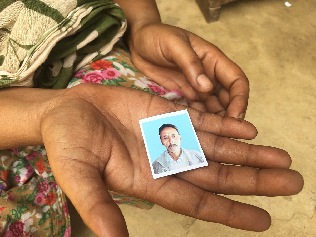 Savita holds the photograph of her dead husband, Gangaram.
