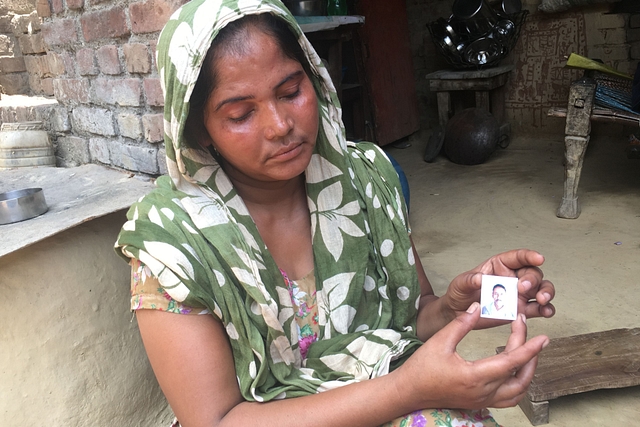  Savita holds a photograph of her husband Gangaram Singh Chauhan who was lynched to death last week in Uttar Pradesh. [Source: Swati Goel Sharma]