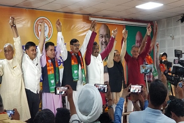 Congress members with BJP’s national secretary Ram Madhav after joining the party (@Arslan64626563/Twitter)