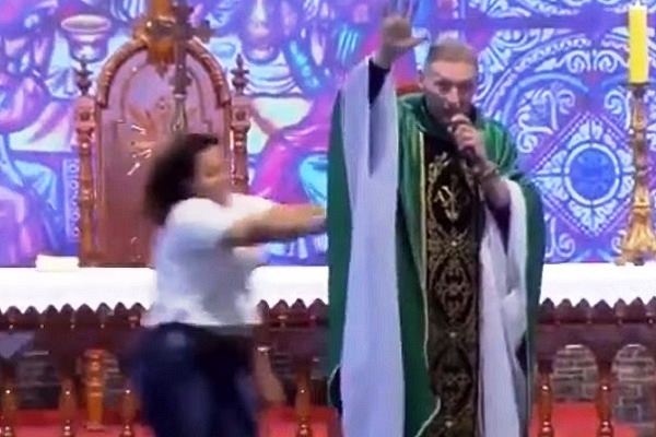 Christian pastor right before being pushed off stage (Video screengrab)