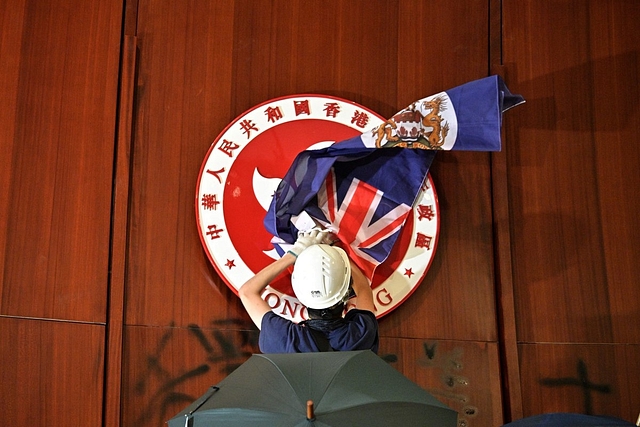 Hong Kong protestors at the city’s legislative house with old colonial flag as a mark of protest against the current rule. (via Twitter)