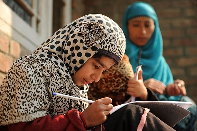 Kashmiri students study outside a house on the outskirts of Srinagar. (TAUSEEF MUSTAFA/AFP/Getty Images)