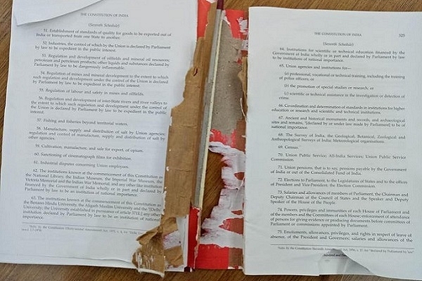 Copy of the Indian Constitution torn by PDP MPs (@ANI/Twitter)